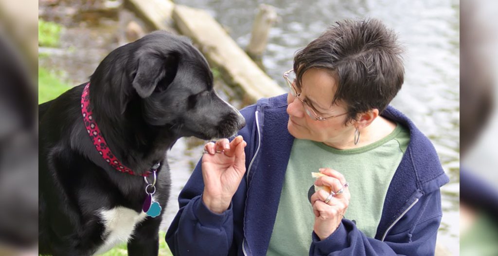 woman sits with dog
