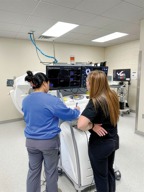 hospital staff examining screen